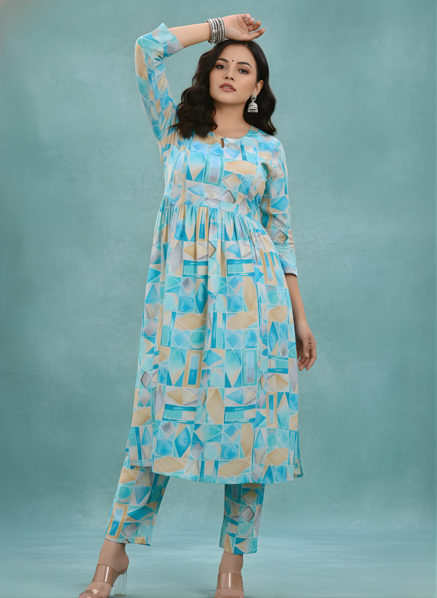 Woman wearing a blue and white patterned outfit against a teal background