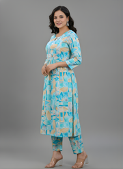 Woman wearing a blue and beige patterned kurta with pants on a gray background