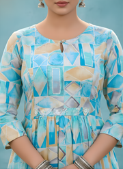 Person wearing a blue and beige geometric patterned dress against a light blue background